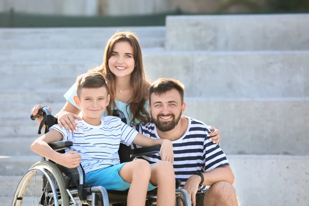 Family posing with child in a wheelchair, after creating a special needs trust